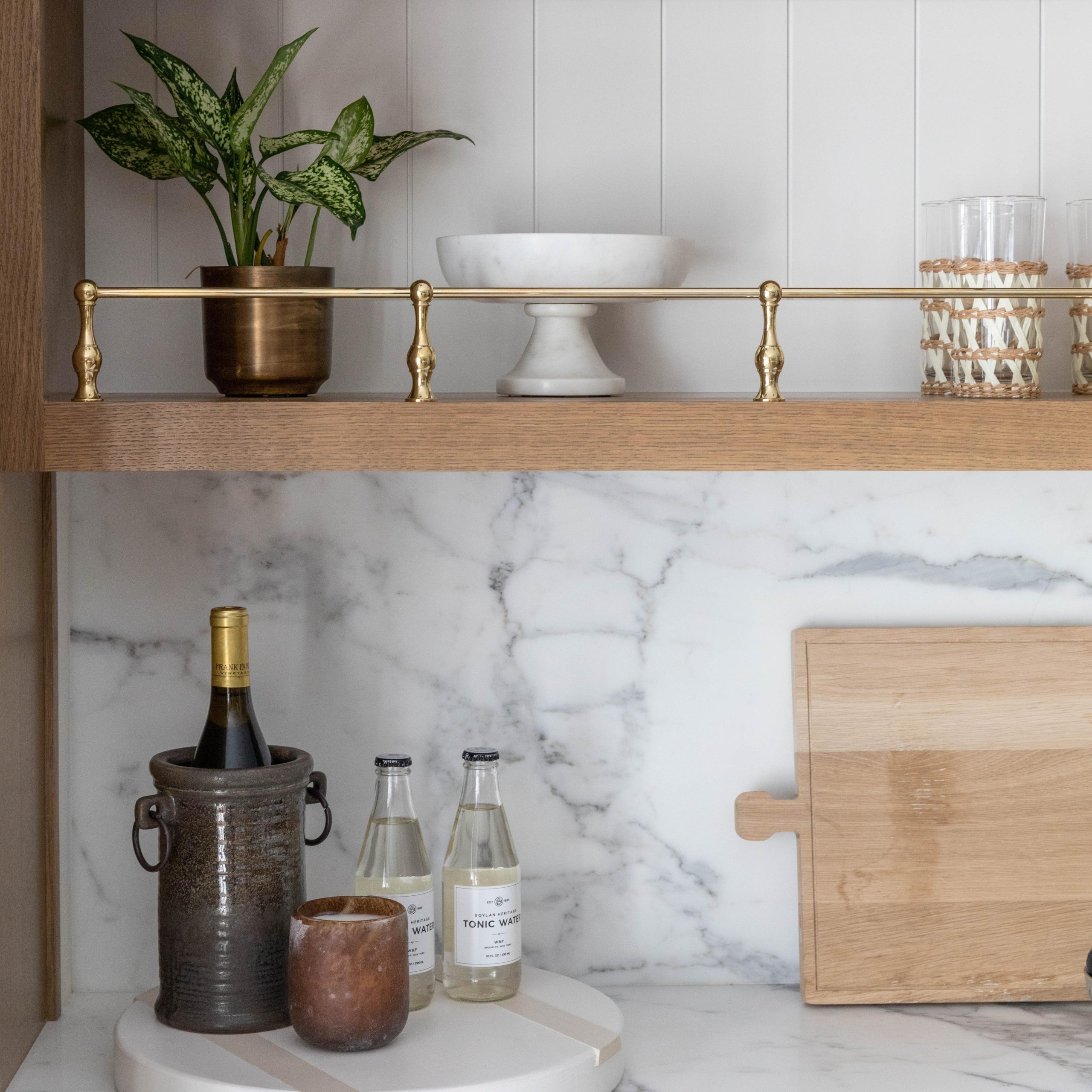 Traditional style Gallery Rails in polished brass mounted on a wood shelf