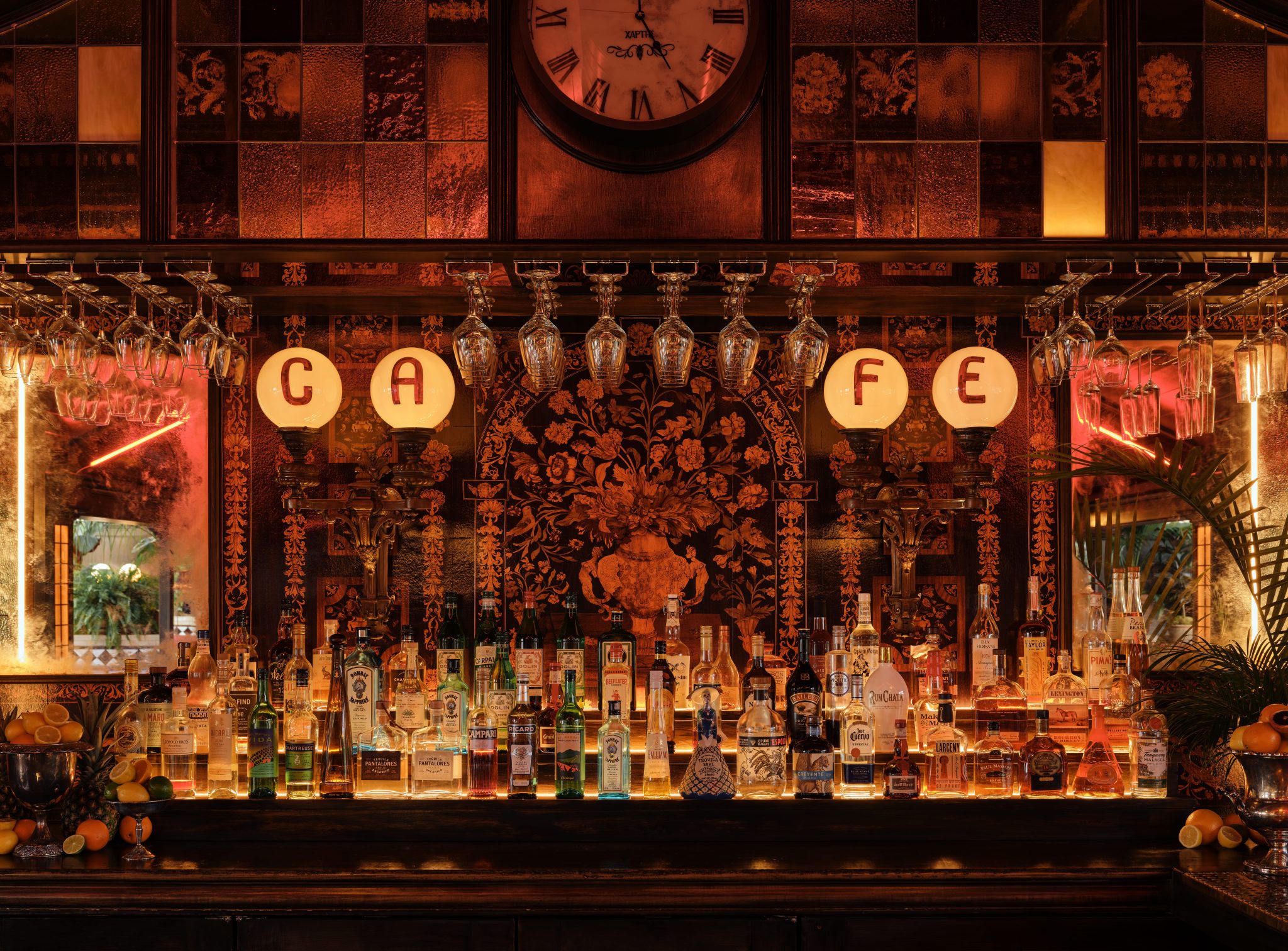 Stemware holders at El Royal bar. Mounted to wood shelving