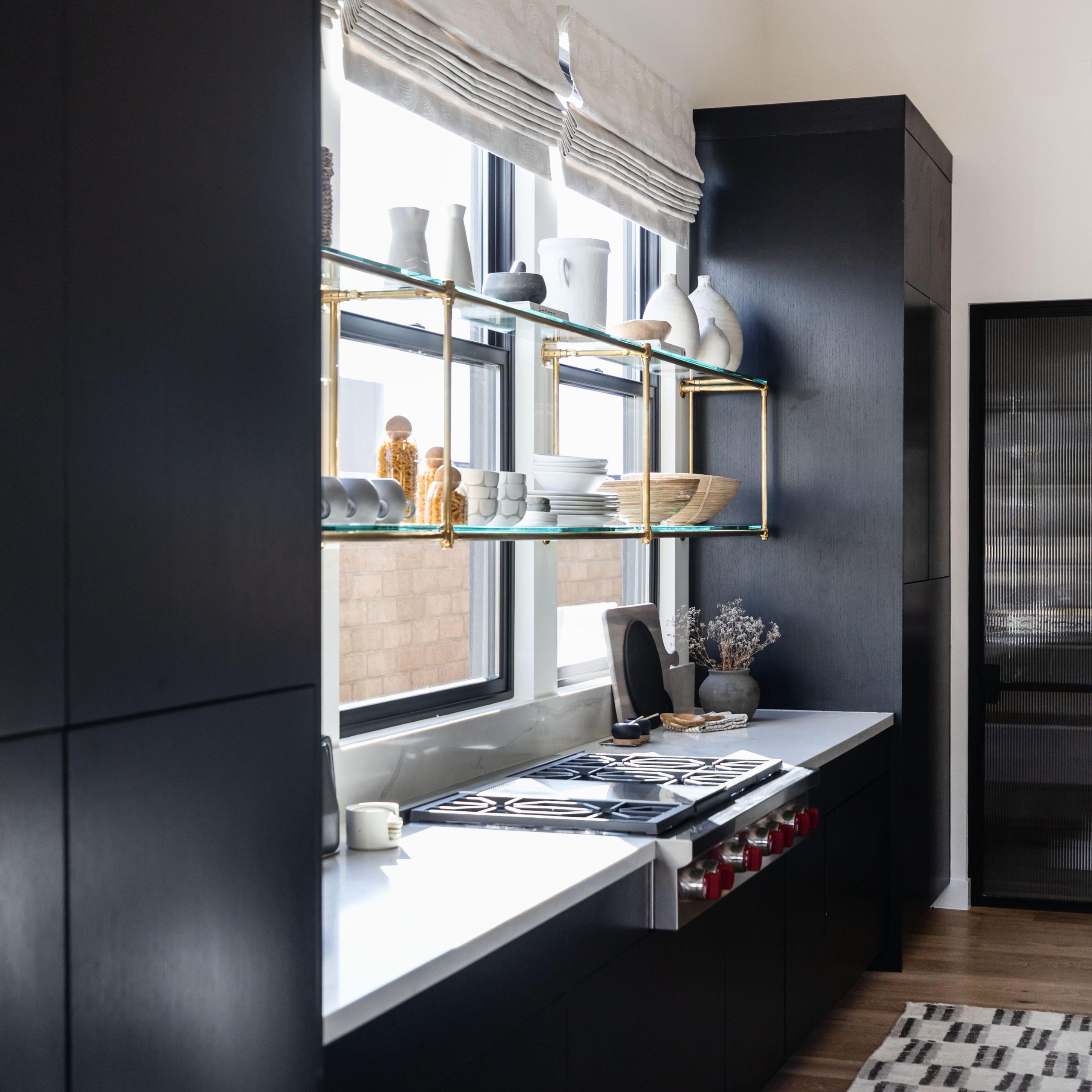 Wall-mounted Studio style Bistro Designer Shelving with glass shelves in front of a window