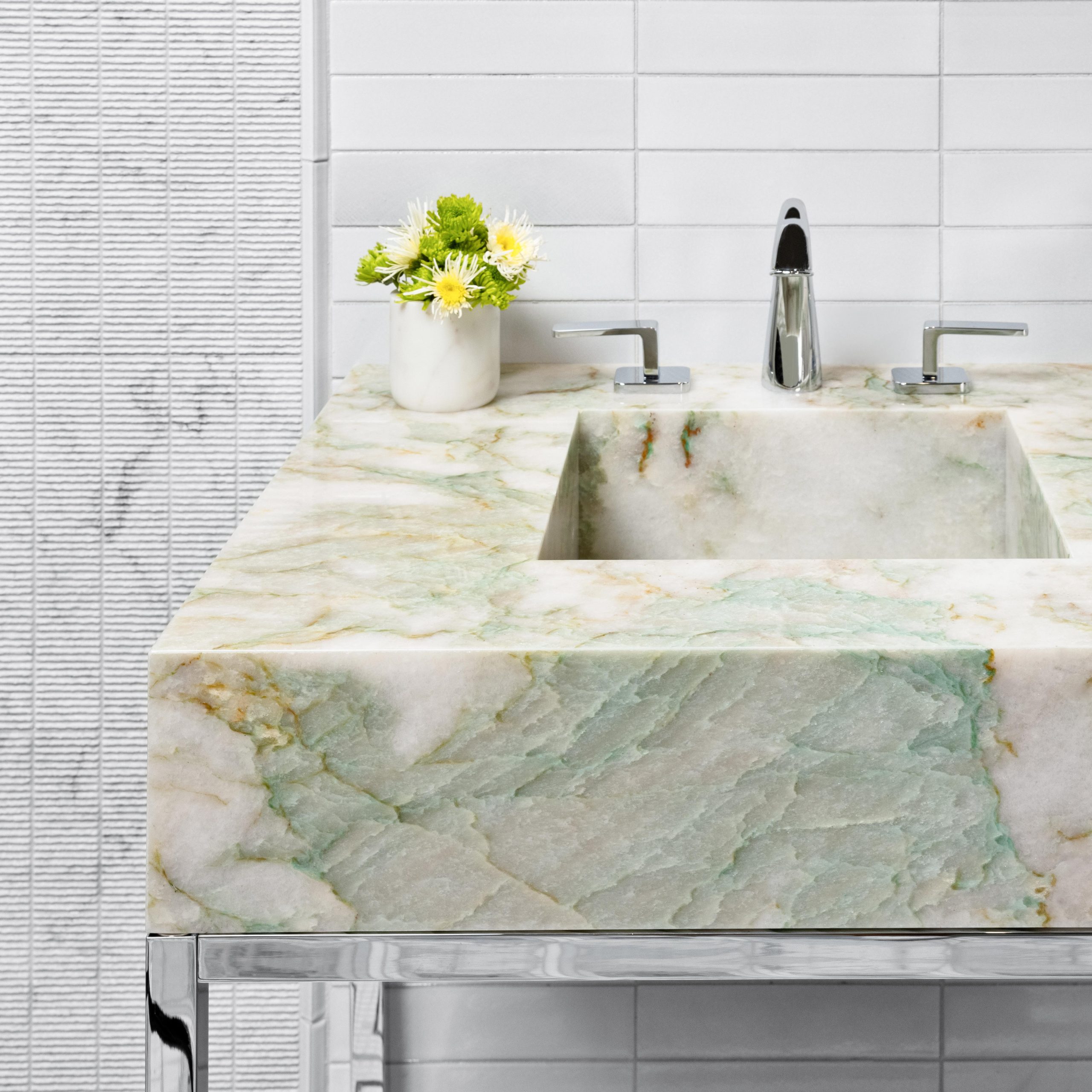 Detail of Linear style Vanity Leg System in polished nickel with solid quartz sinktop