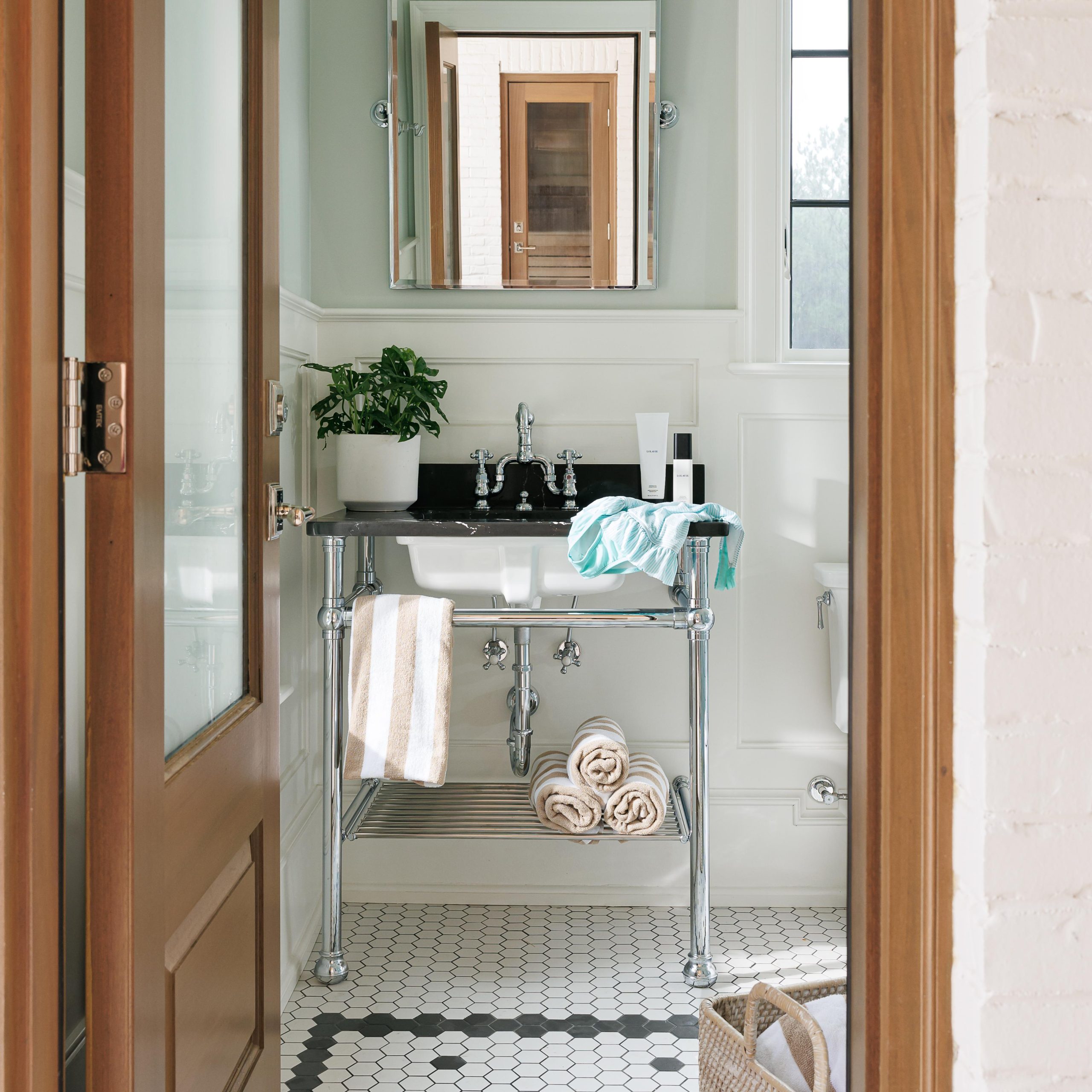 Bun Foot style Vanity Leg System in polished chrome with a Hotel style tubular metal shelf and Low-Profile shelf supports