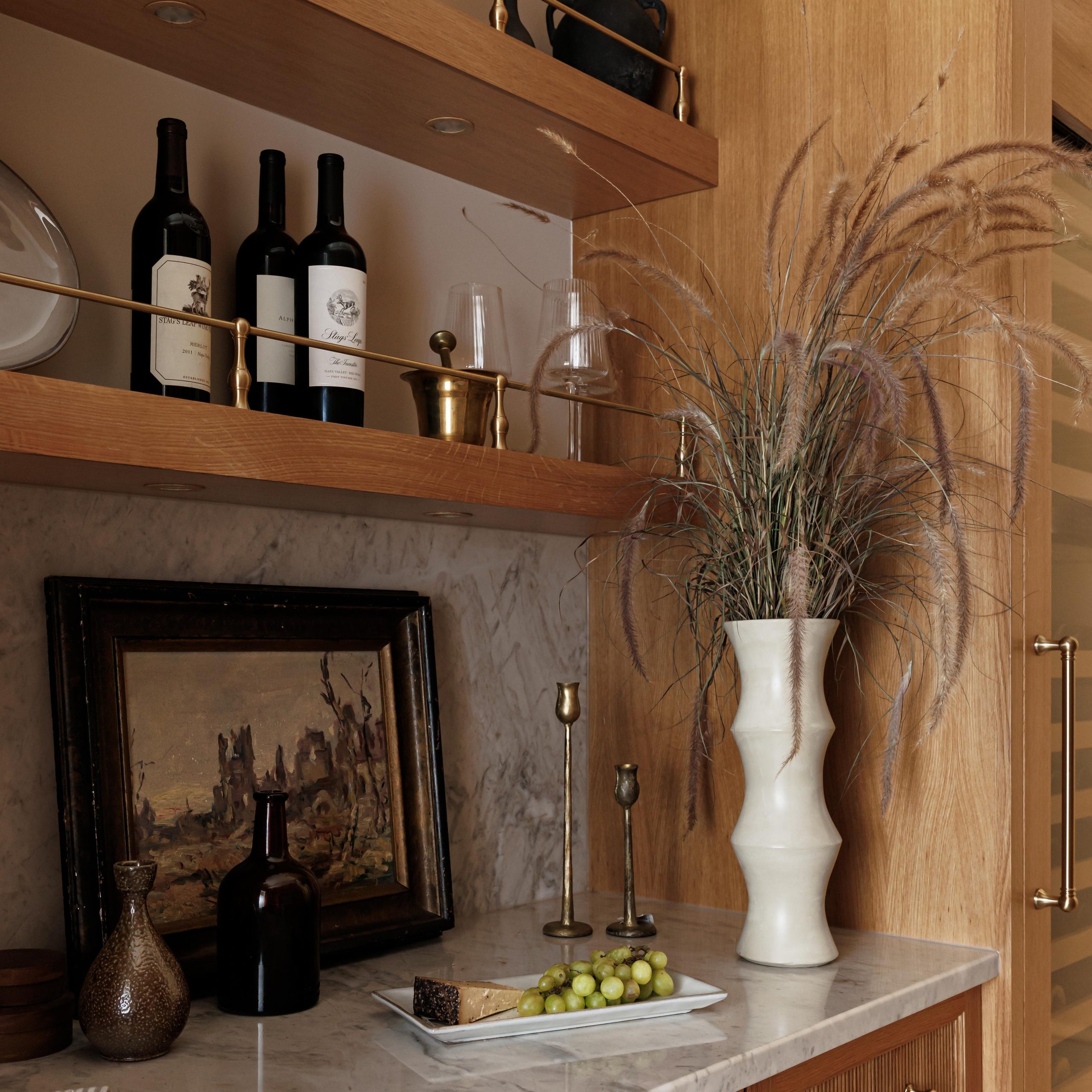 Traditional style Gallery Rails in polished brass on a wood shelf