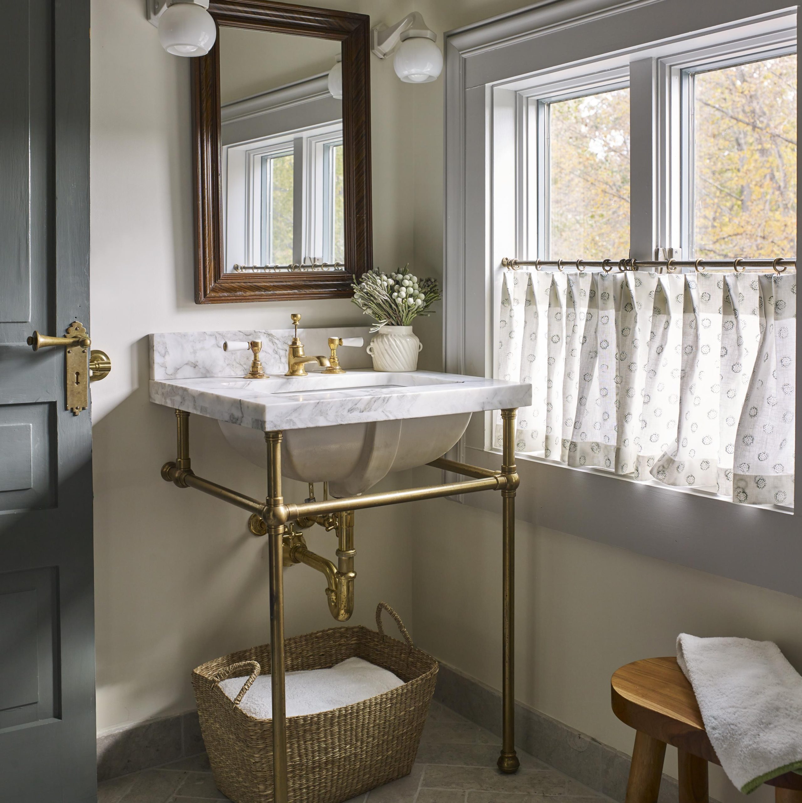 BunFoot style Vanity Leg System in aged brass with a marble top