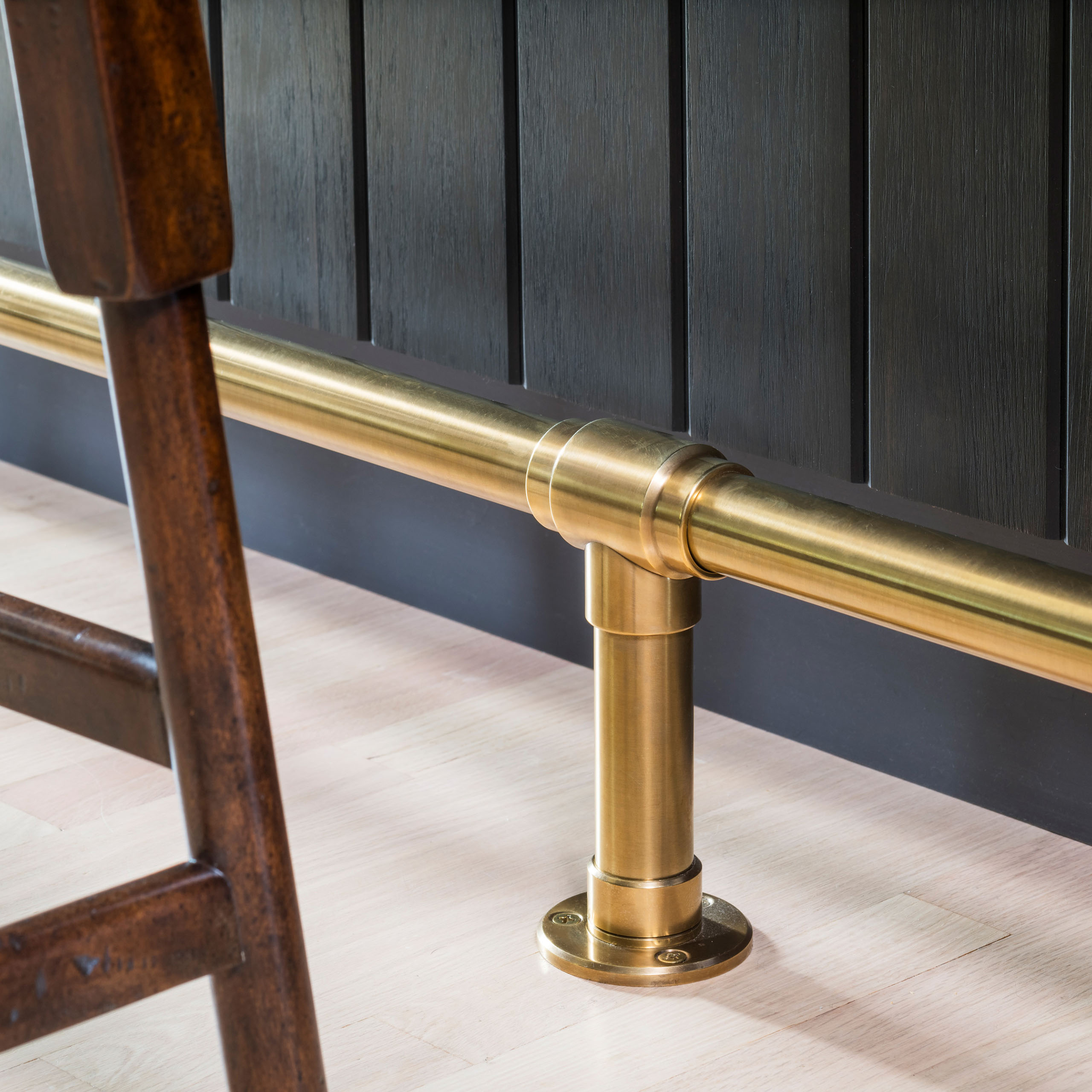 Satin Brass finished Studio style Foot Rail with Exposed-Screw Flange floor mounts