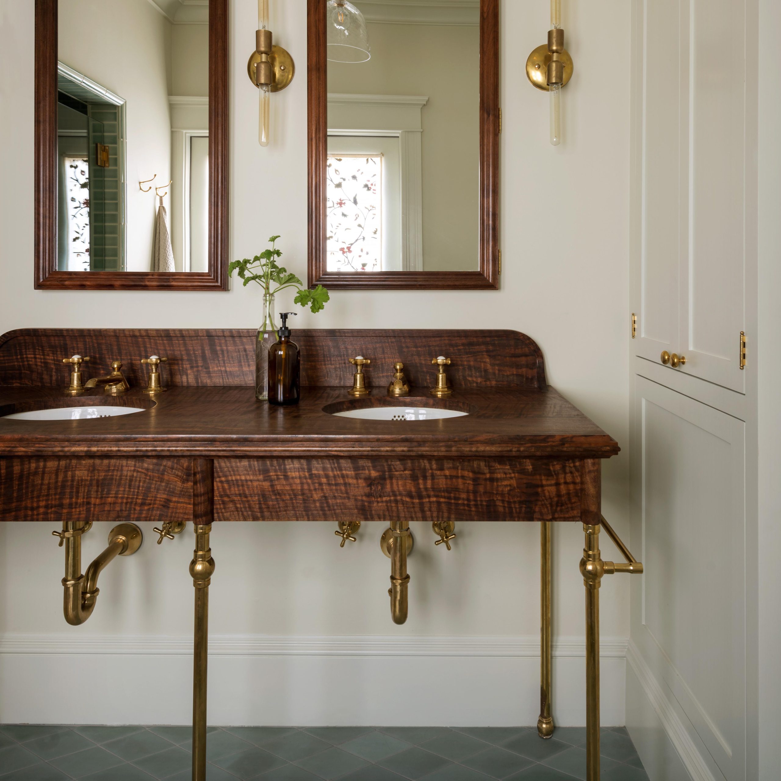 Victorian style Vanity Leg System in aged brass with a beautiful wood countertop with backsplash and aprons