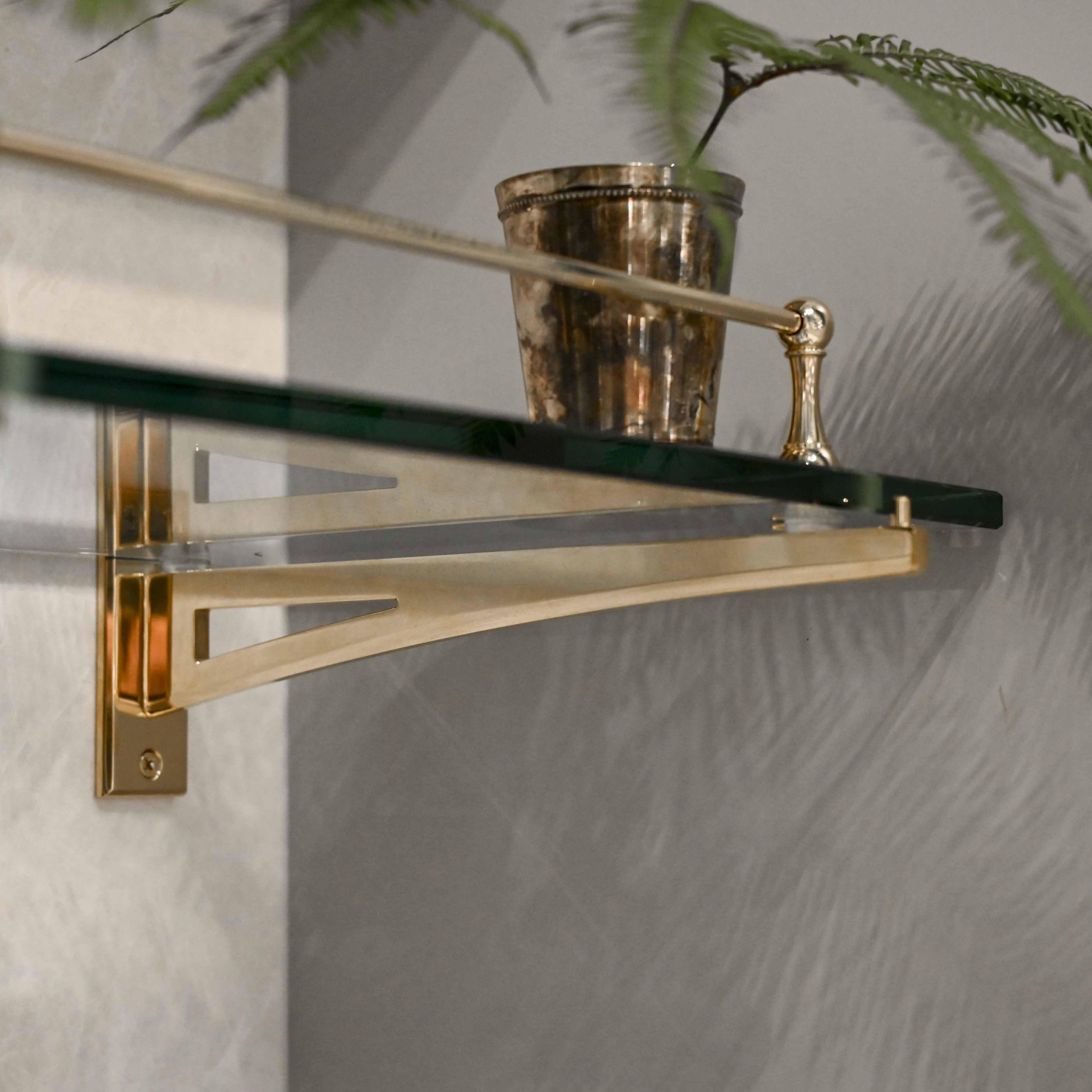 Rack style Cantilever Shelving Bracket with a glass shelf and Traditional style Gallery Rail in brass