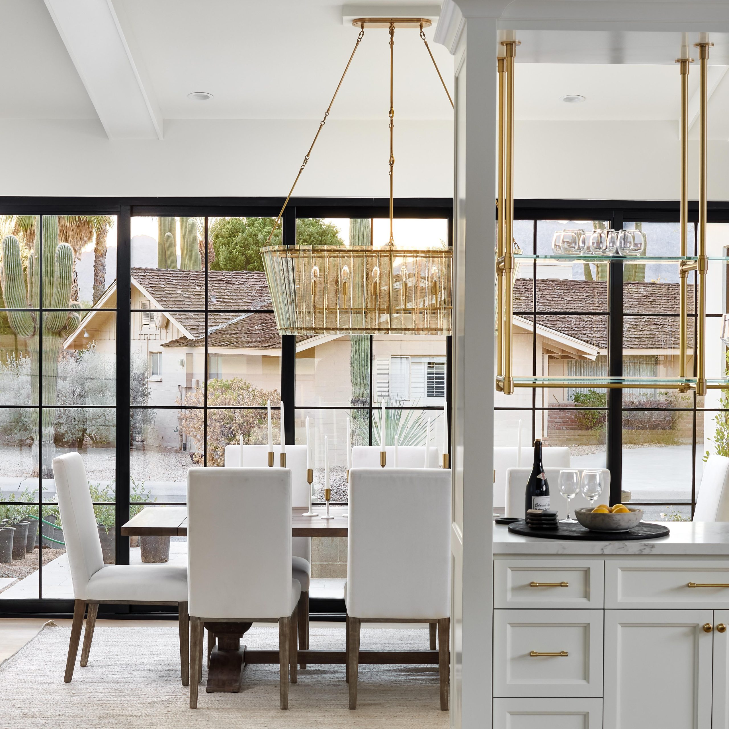 Ceiling-mouned Studio style Bistro Designer Shelving in polished brass with glass shelves featurig a unique custom center of shelf support crossbar