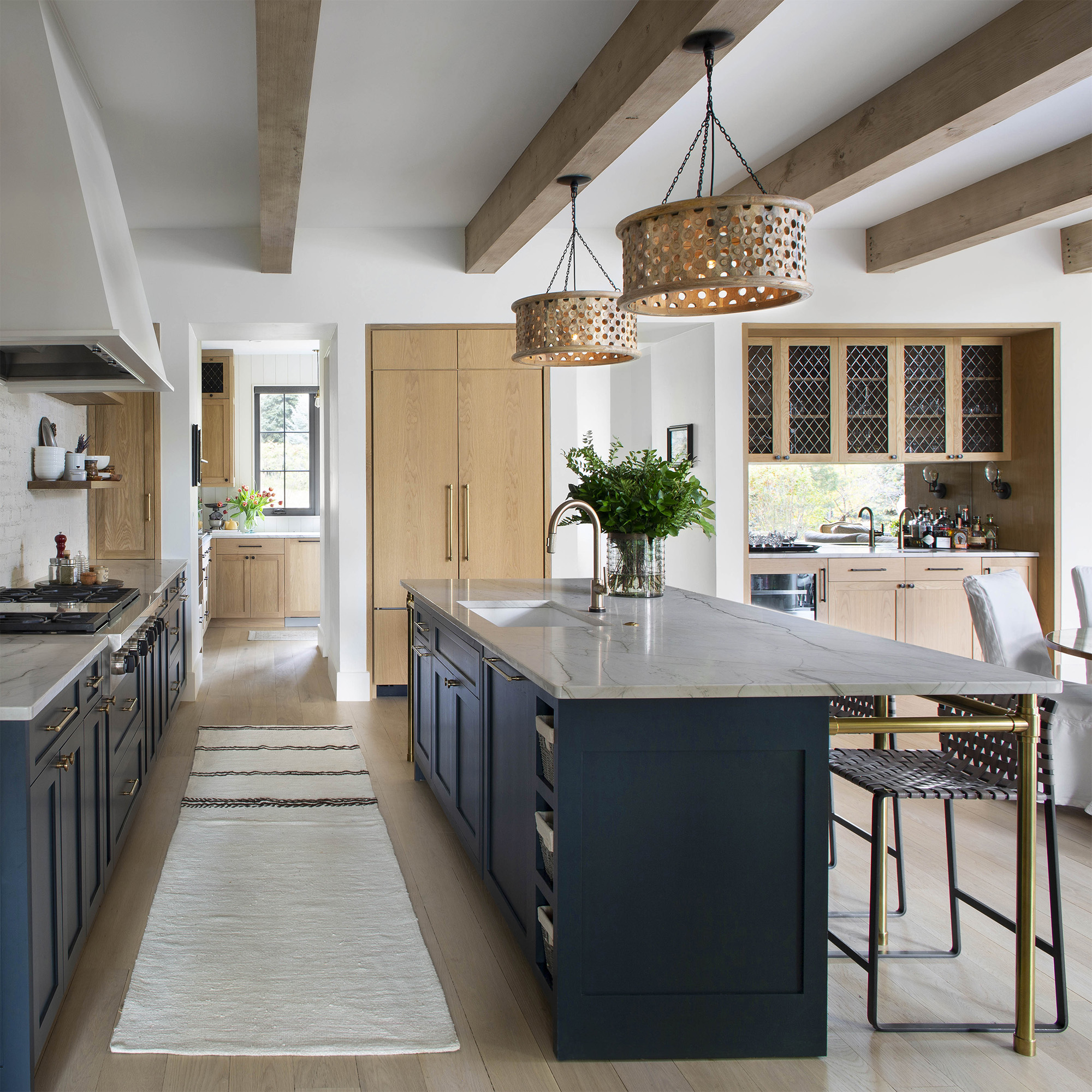 A Studio style Kitchen Leg System in aged brass supporting a countertop overhang